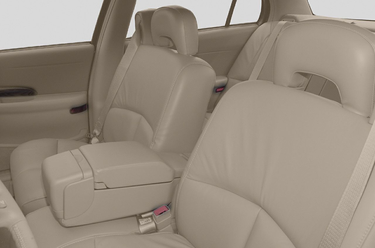 Beige leather car seats with center armrest and seatbelts