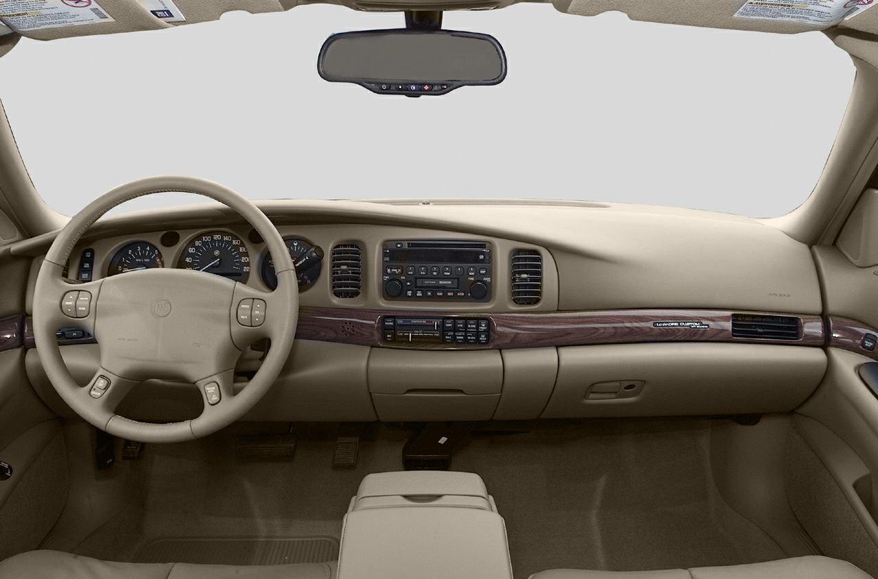 Dashboard with wood trim and analog gauges, beige interior
