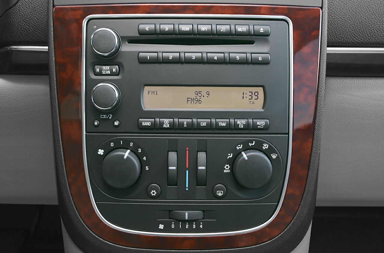Compact audio unit and climate control knobs with wood trim accents