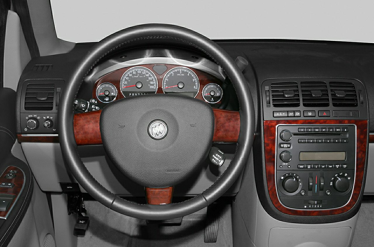 Wood-trimmed steering wheel and classic dashboard cluster with center console controls