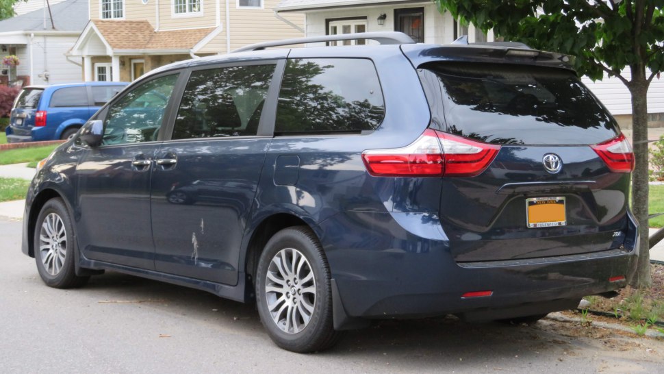 Rear and side view of a minivan with sliding door and distinctive tail lights