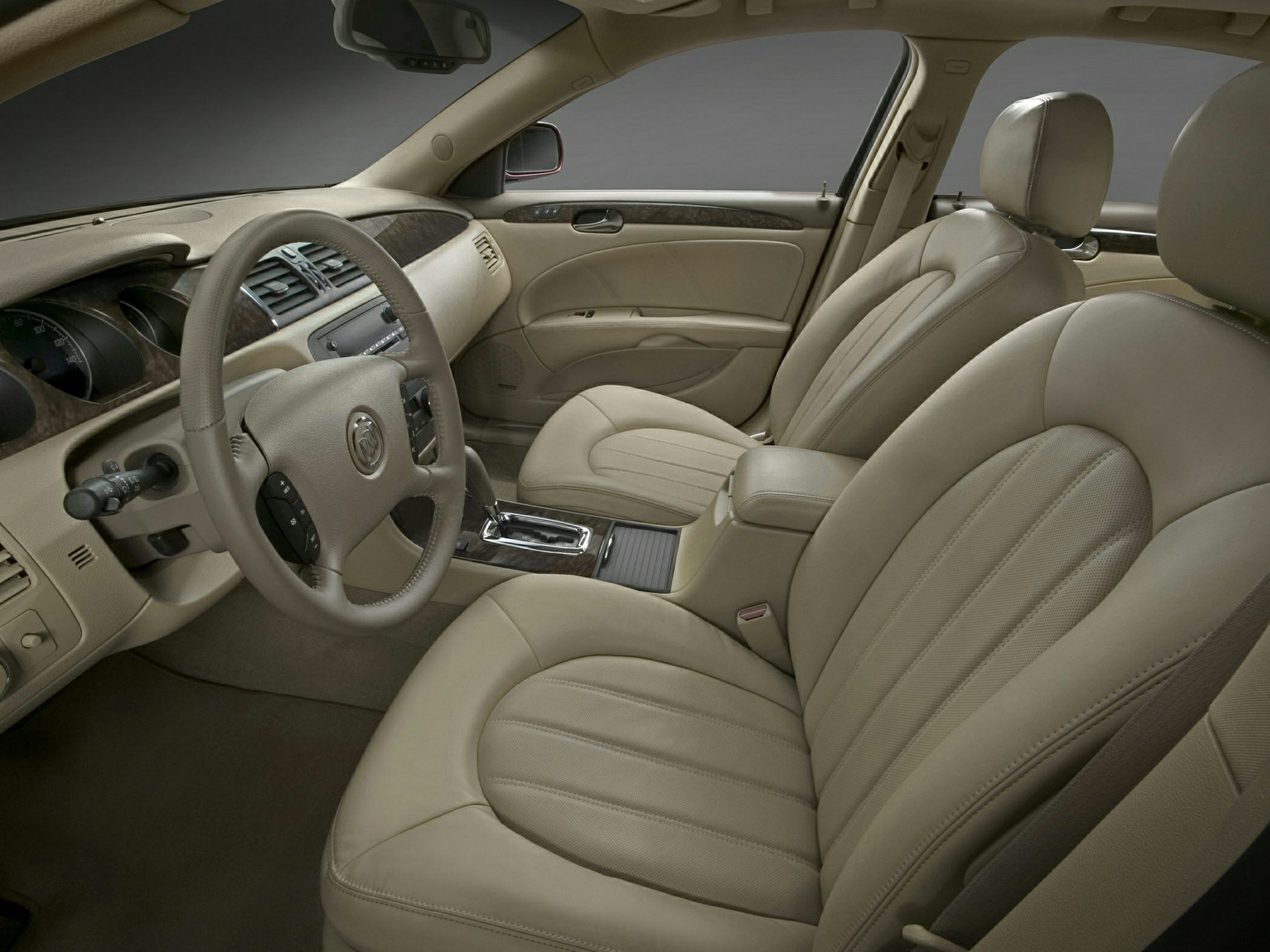 Beige leather seats and detailed dashboard with wood trim