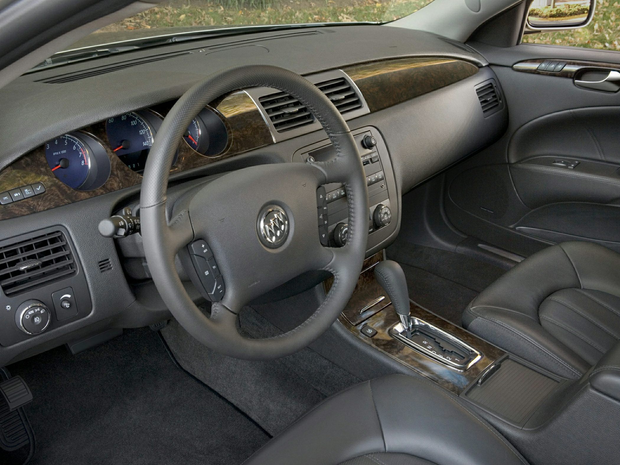 Leather steering wheel, wood dashboard trim, and automatic gear shifter