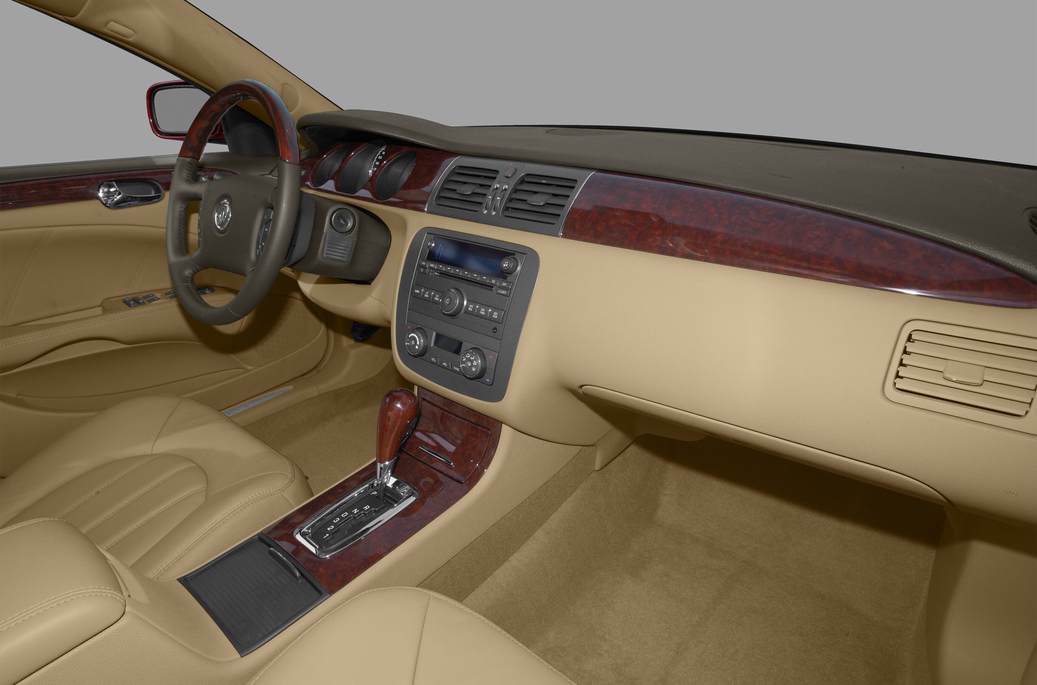 Beige leather interior with wood trim and automatic gear shift