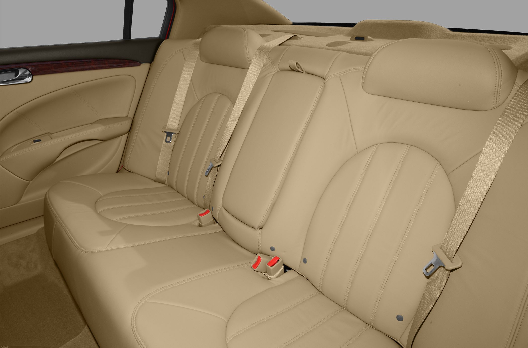 Beige leather rear seats with seat belts and wood trim
