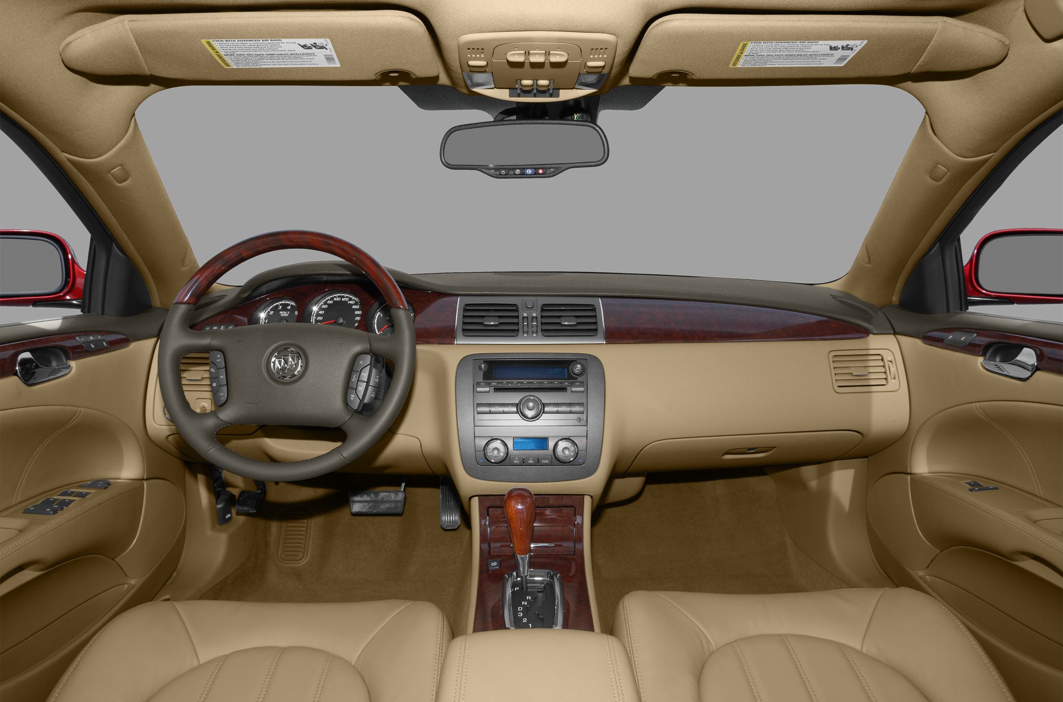 Dashboard, steering wheel with controls, beige interior, wood trim center console