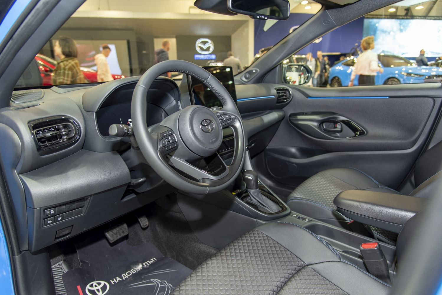 Modern steering wheel and dashboard interior design with fabric and leather seats
