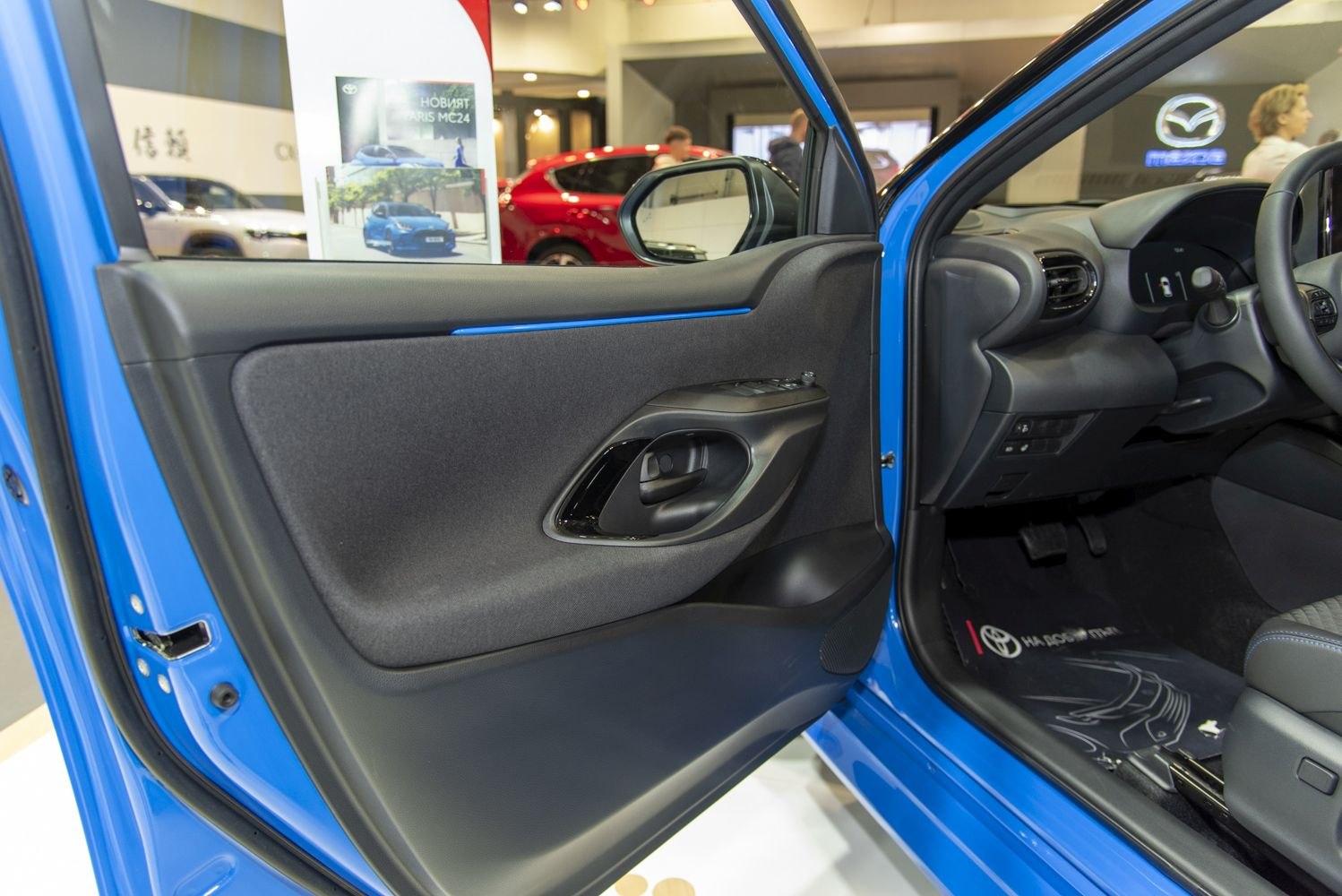 Modern car door panel interior with ergonomic handle and control buttons