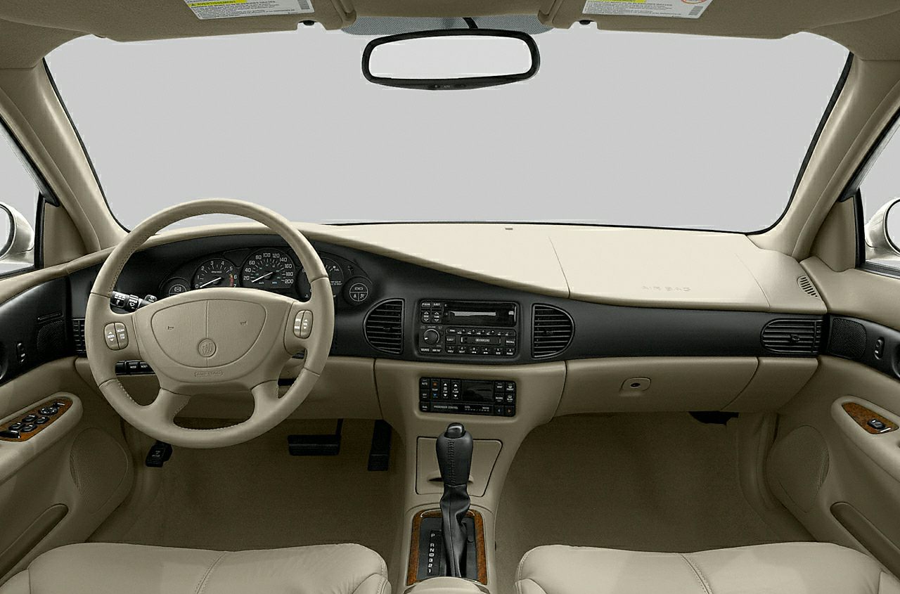 Beige dashboard and steering wheel with wood trim accents