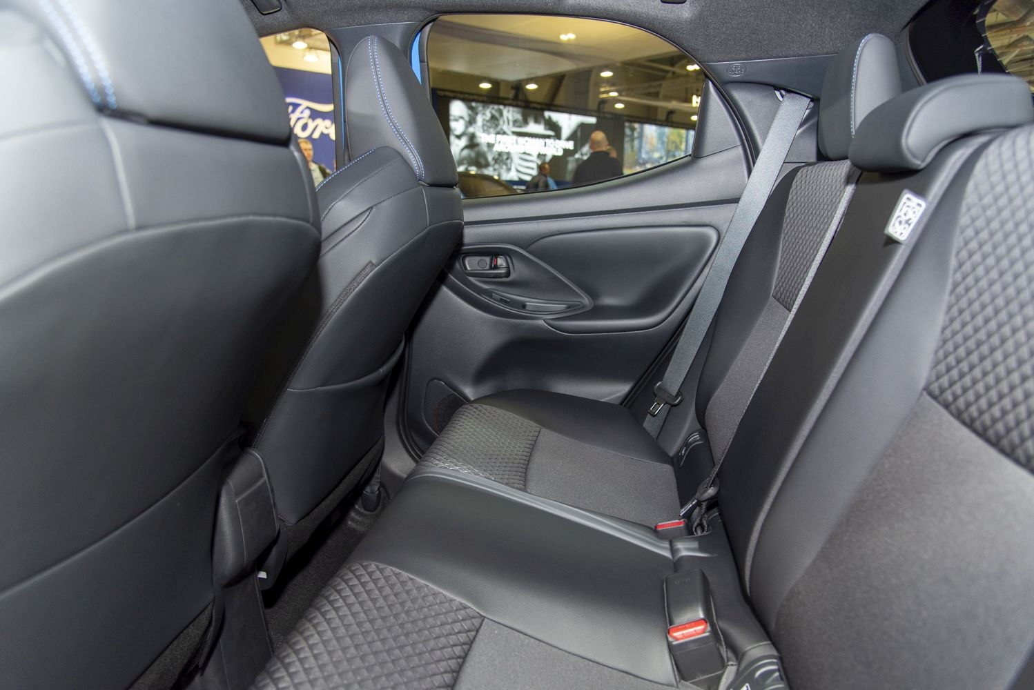 Rear seat interior with leather and fabric upholstery, modern door panel