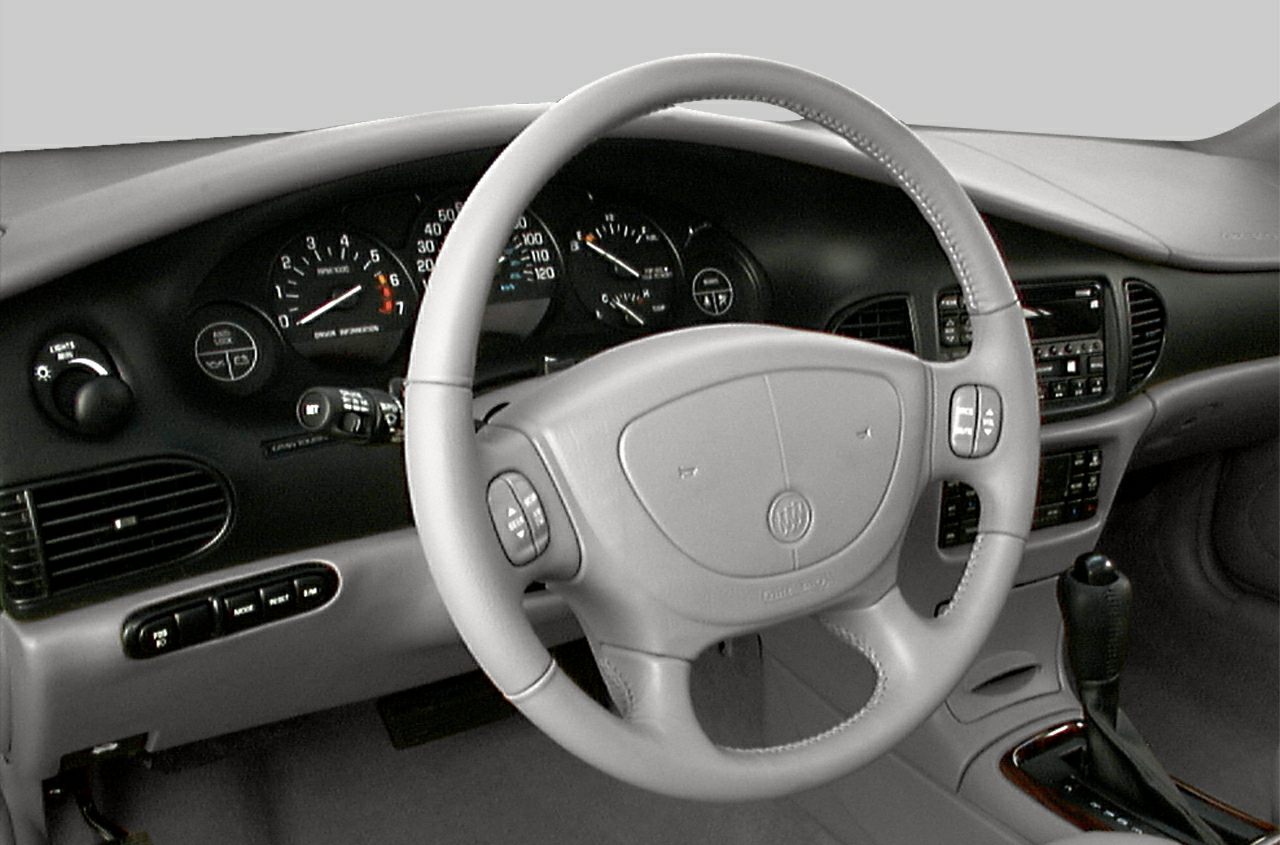 Steering wheel, dashboard with analog gauges, and center console with automatic gear shift