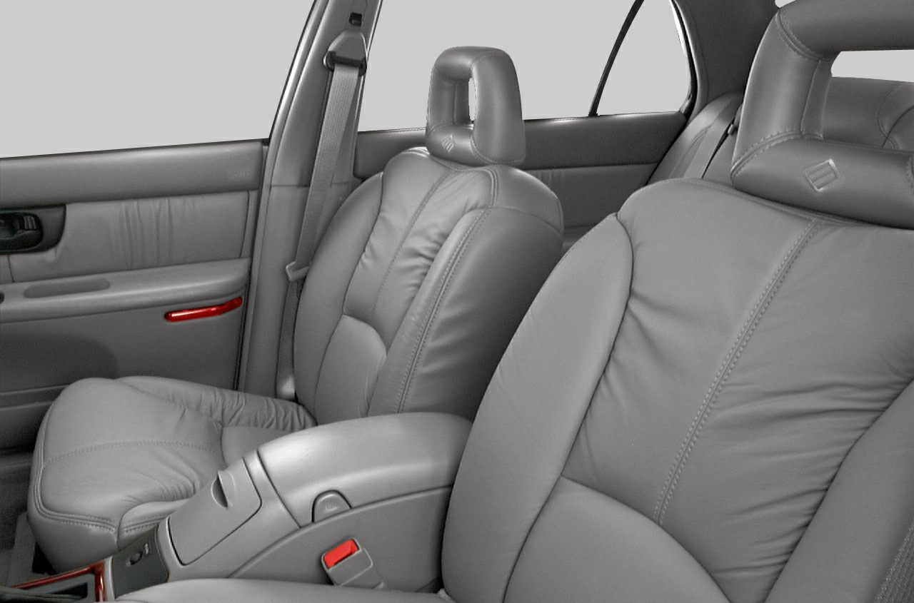 Front leather seats with center armrest and door panel in car interior