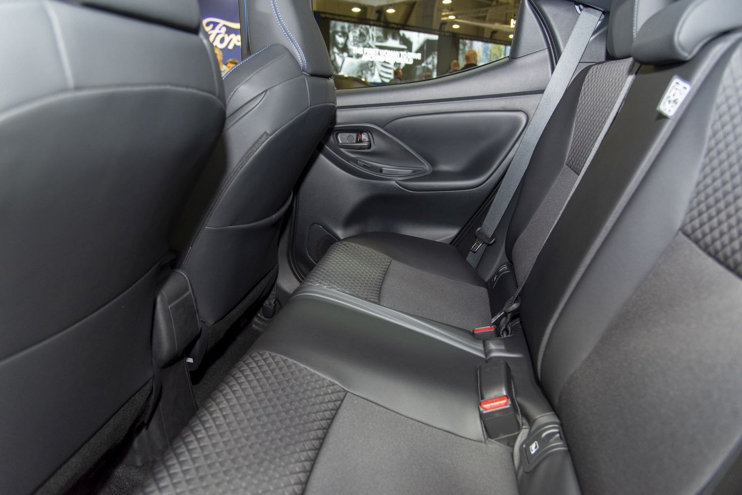 Rear seat interior with ergonomic upholstery and seat belt.