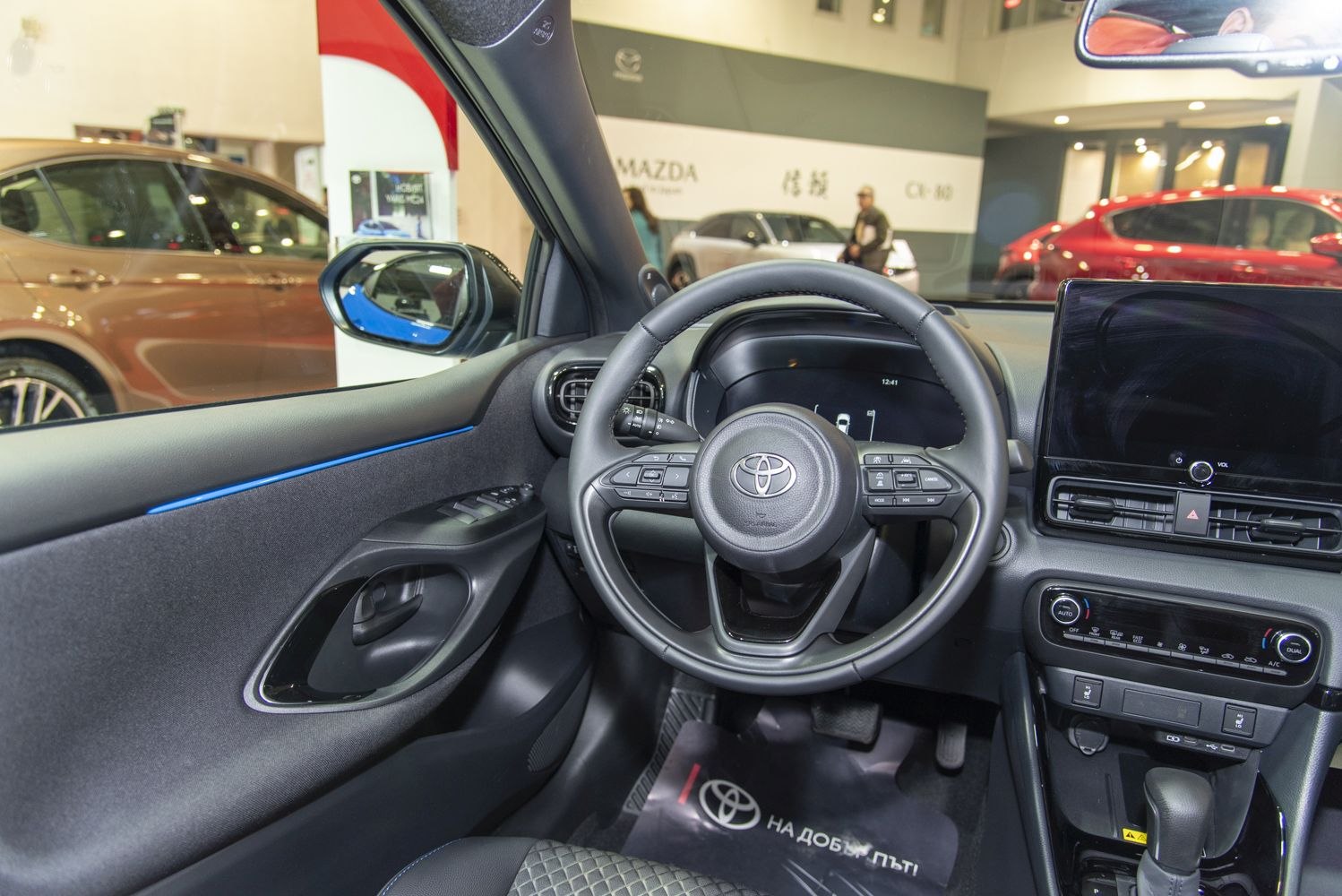 Digital instrument cluster and multifunction steering wheel in car interior