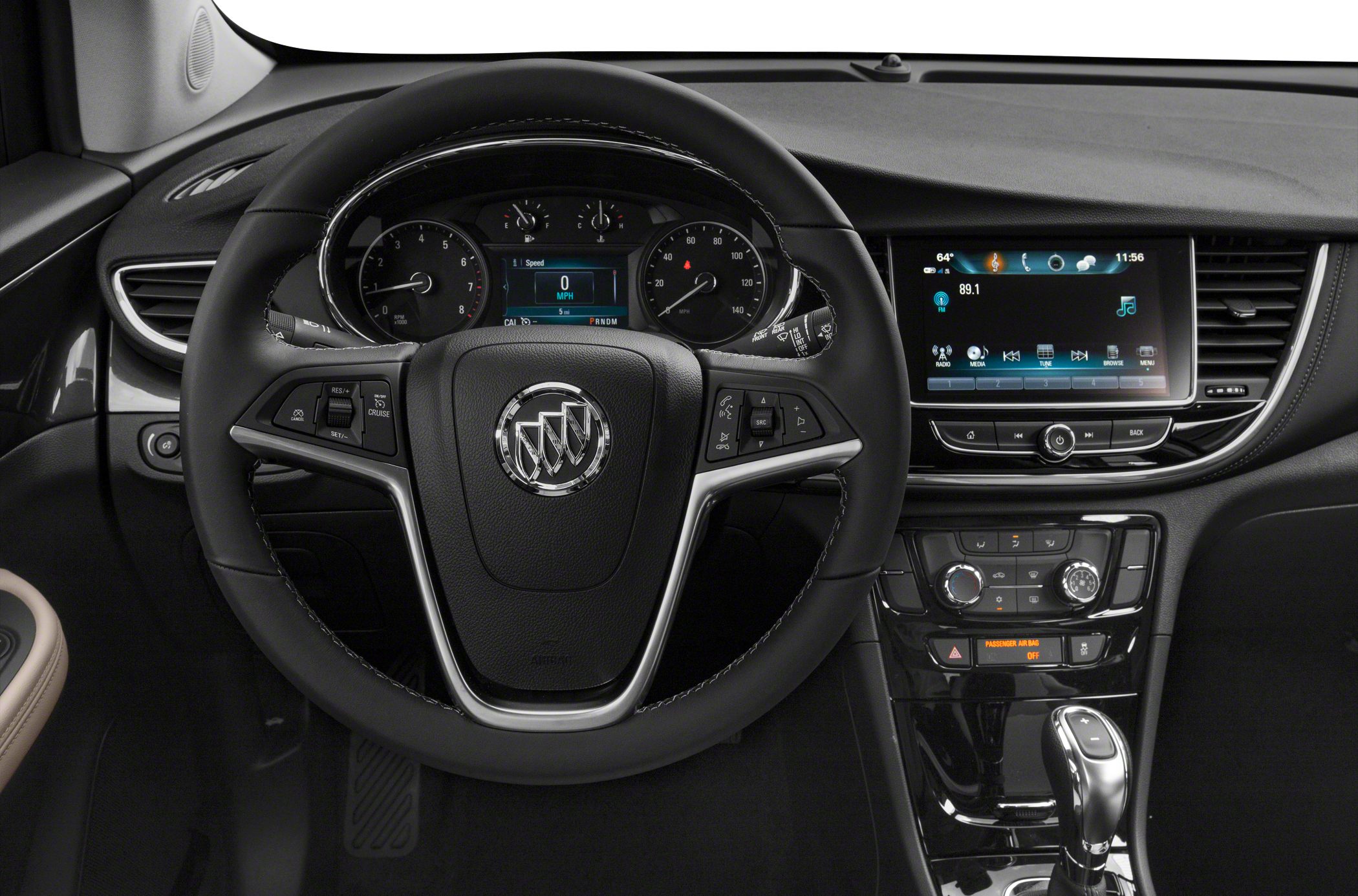 Steering wheel with controls and infotainment screen on dashboard