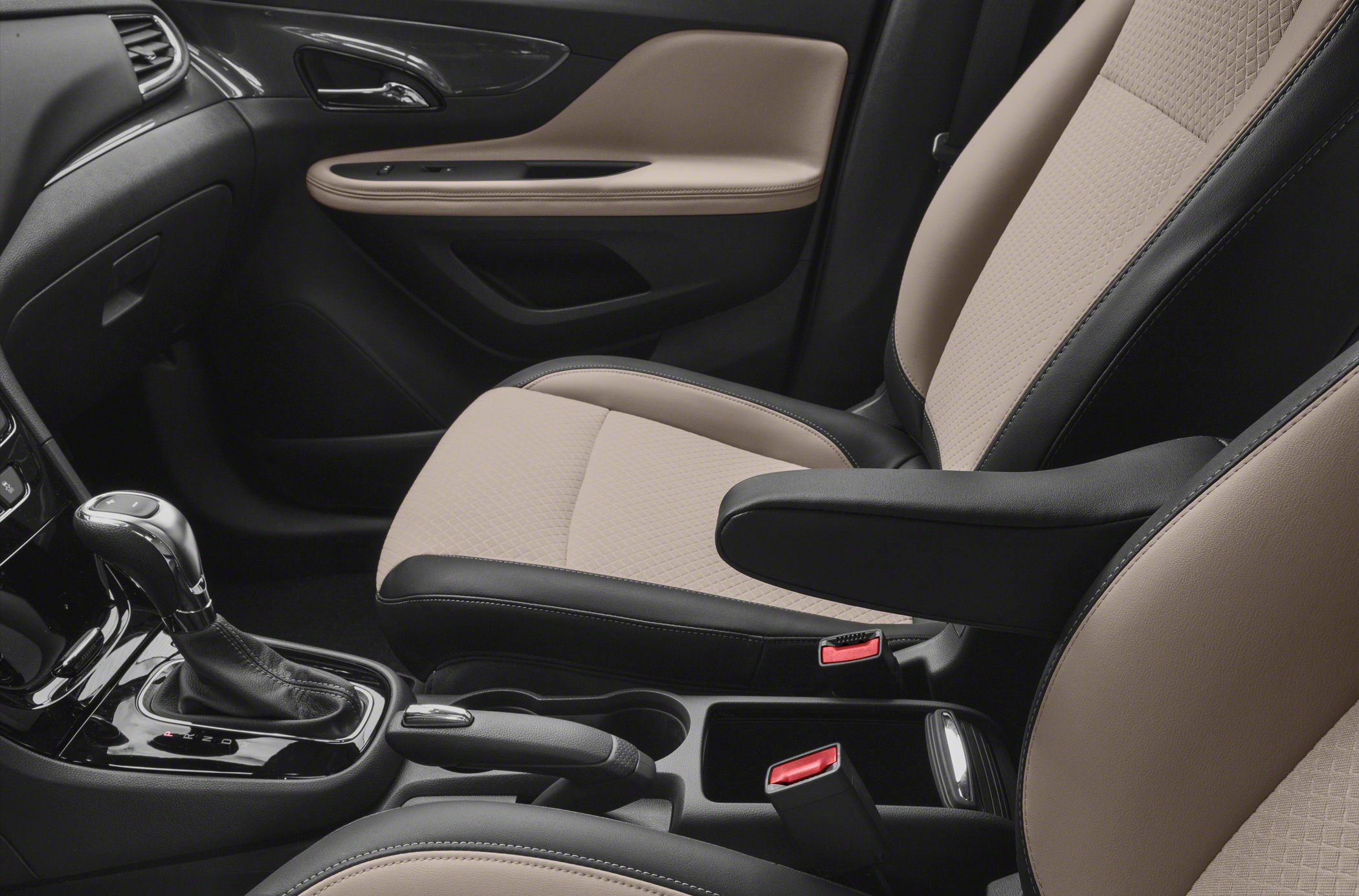 Beige and black car seats with gear shift and center console