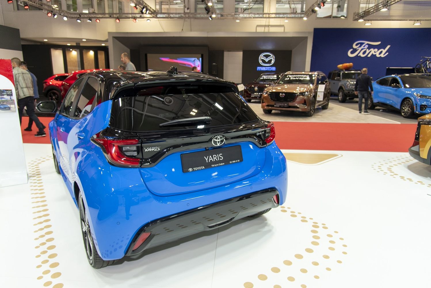 Rear view of a blue hatchback with modern taillights and two-tone roof.