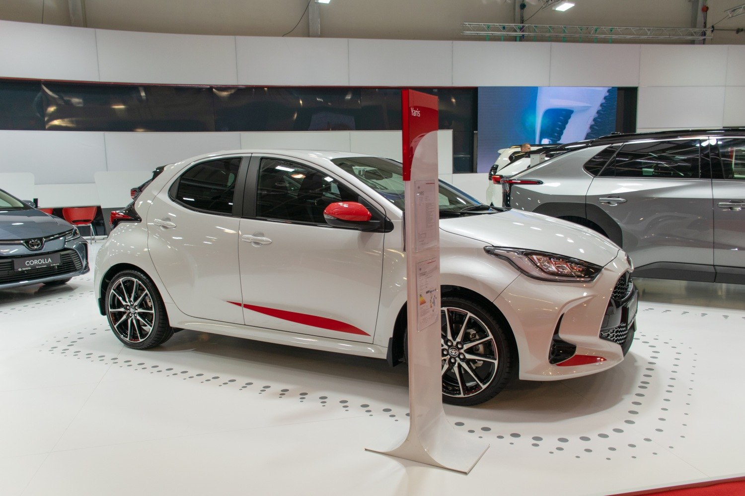 Side profile of hatchback showing alloy wheels and red accent details