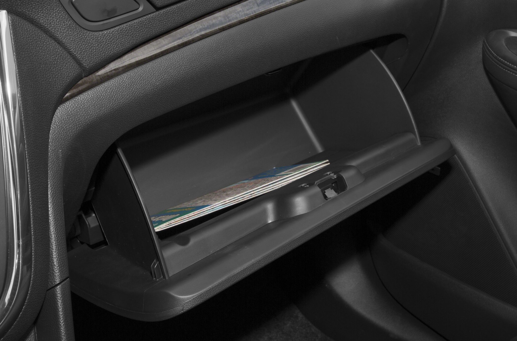 Open glove compartment with map inside