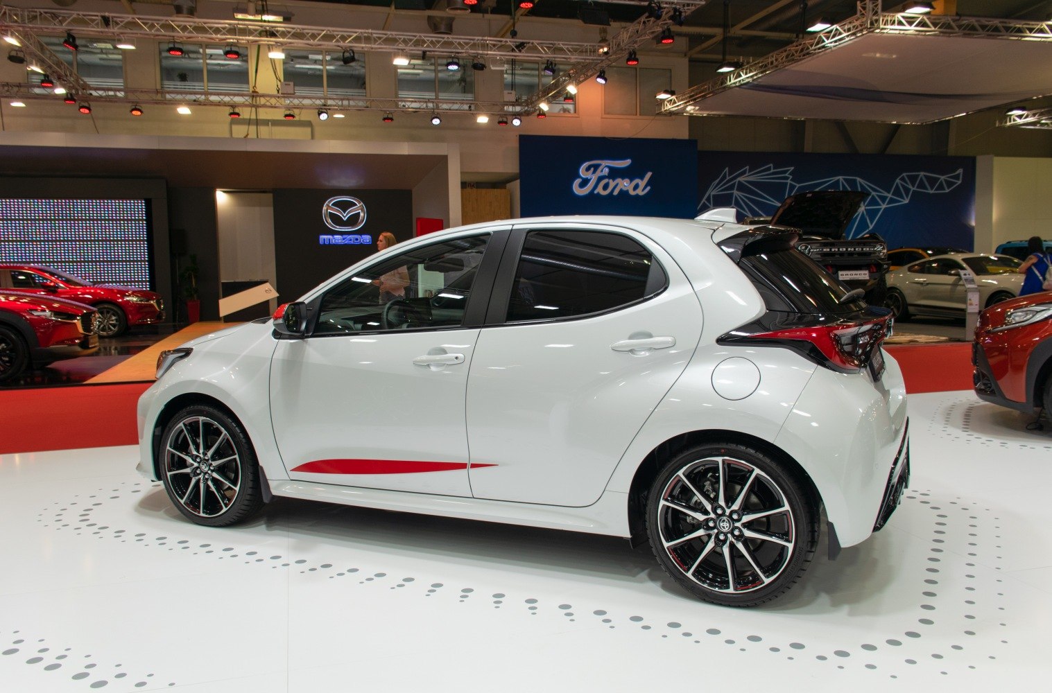 Side profile of a hatchback with alloy wheels and sporty design