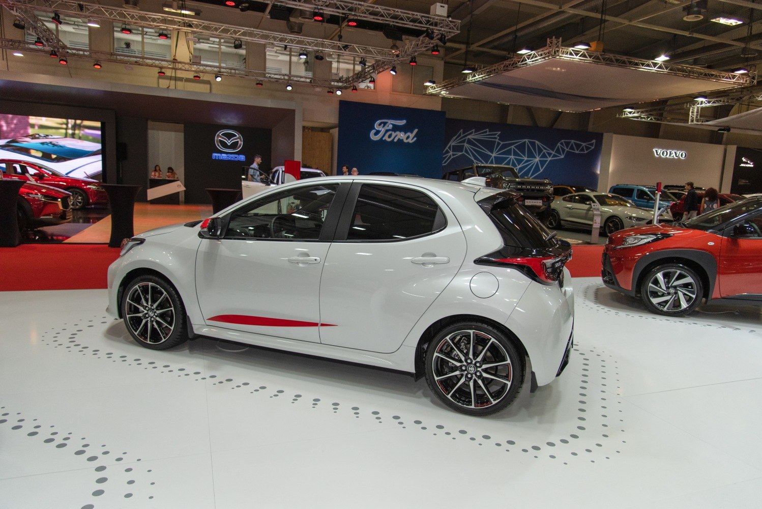 Side profile of a compact hatchback with sporty alloy wheels