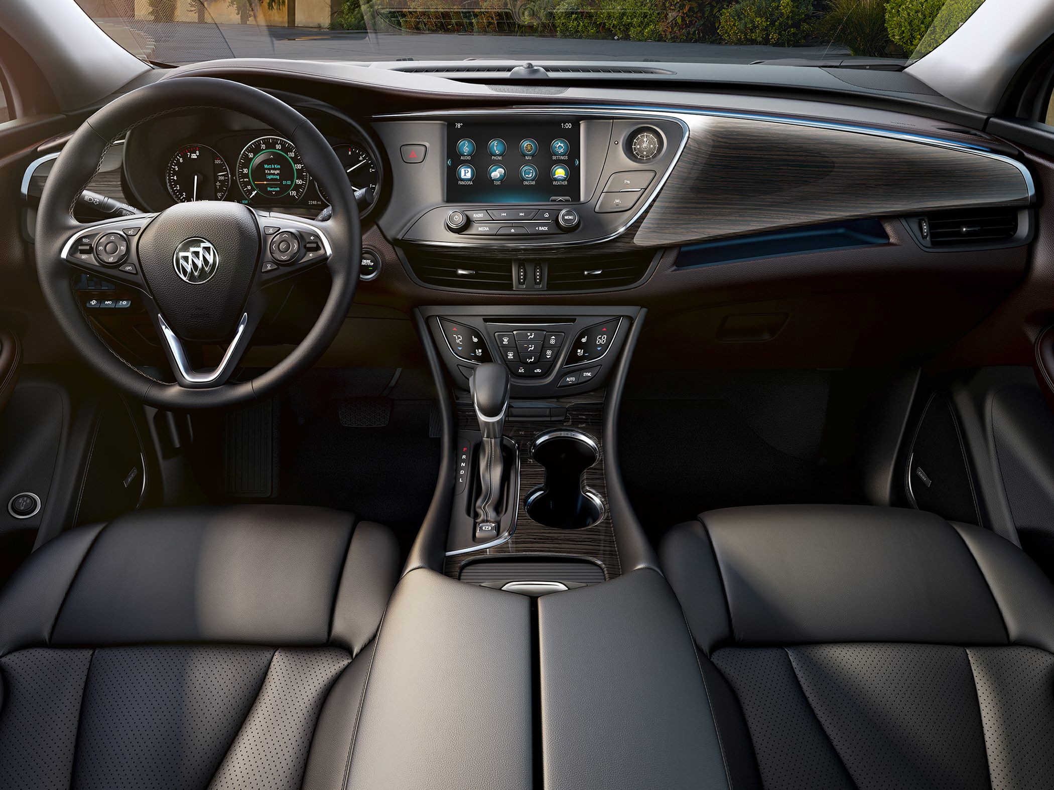 Modern car interior with touchscreen, multifunction steering wheel, and wood trim