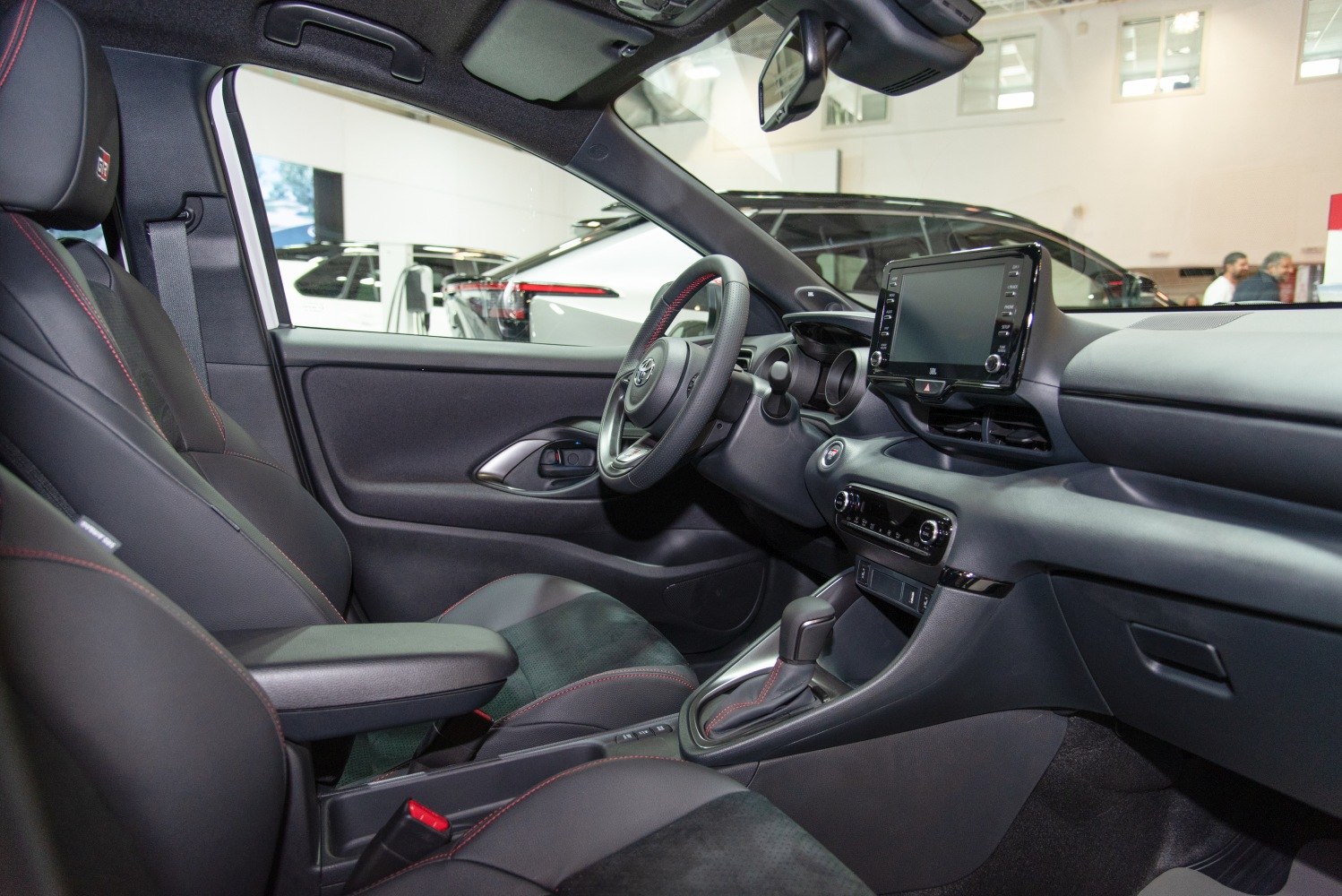 Modern car interior with touchscreen, leather seats, and automatic gearshift