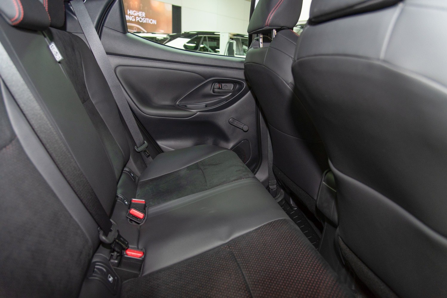 Rear black upholstery car seat with seatbelts and door panel