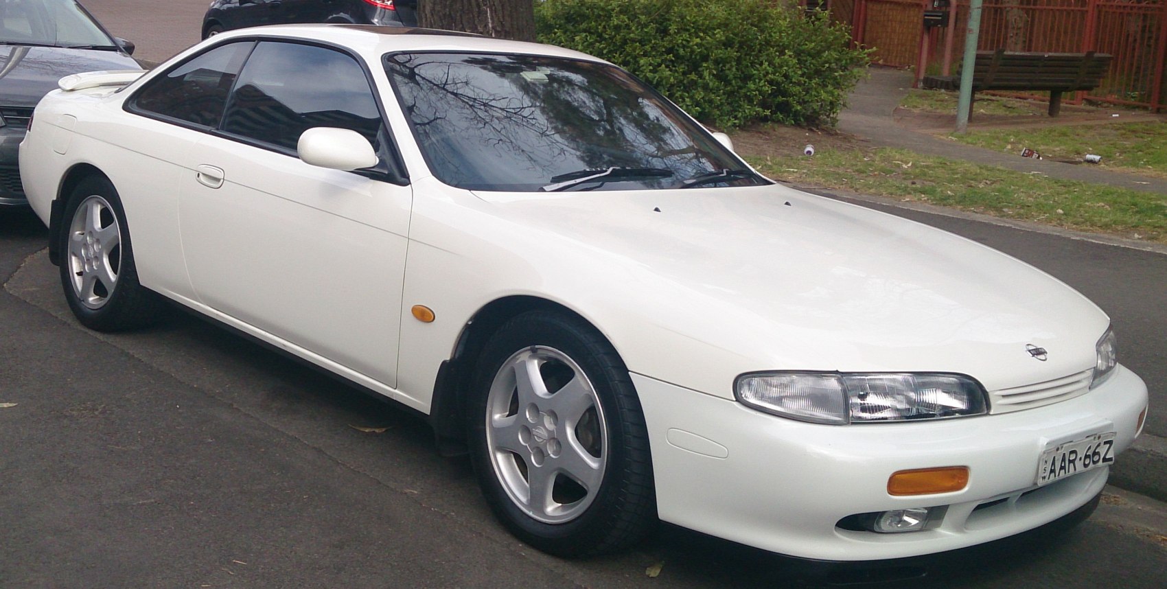 White coupe with distinctive front headlights and alloy wheels