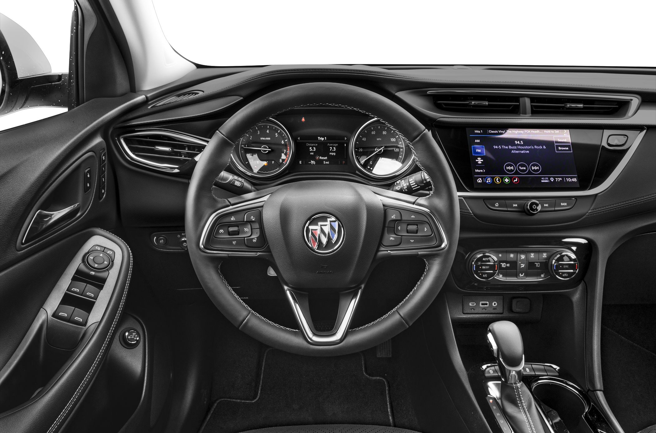Car cockpit includes steering wheel, dashboard gauges, infotainment screen, and climate controls.