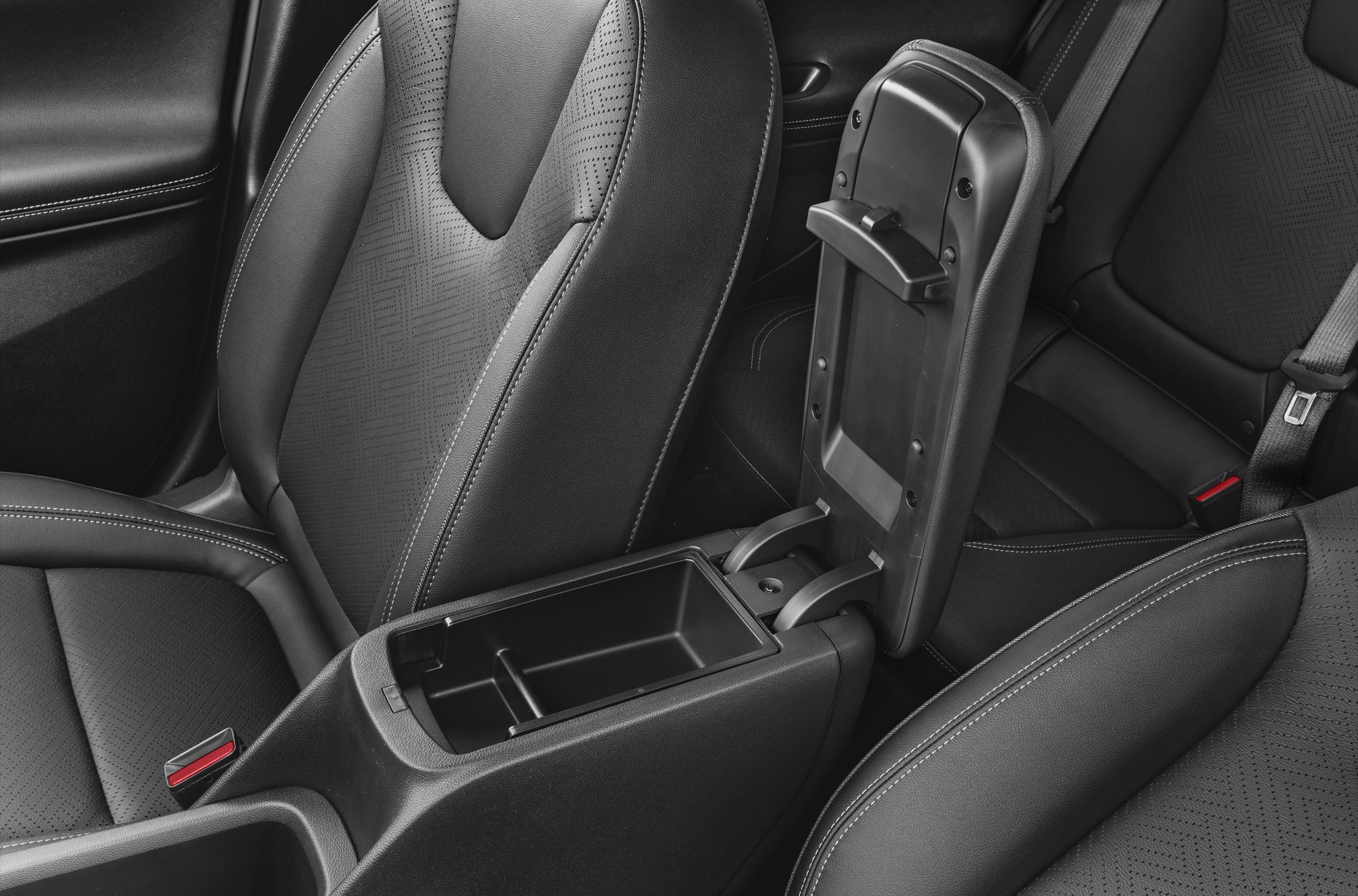Open center console storage compartment between leather upholstered front seats