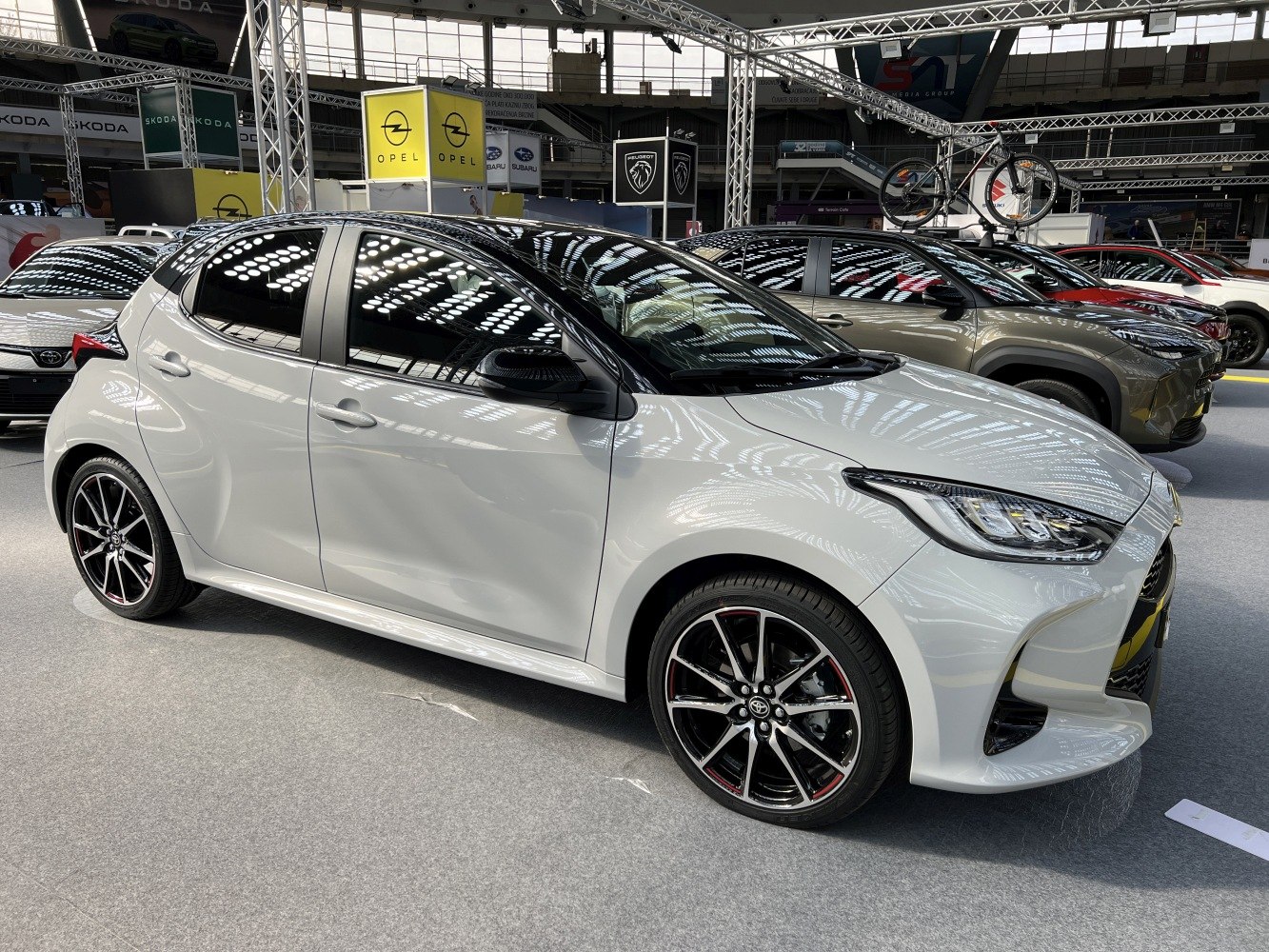White hatchback with sporty black alloy wheels and sleek design