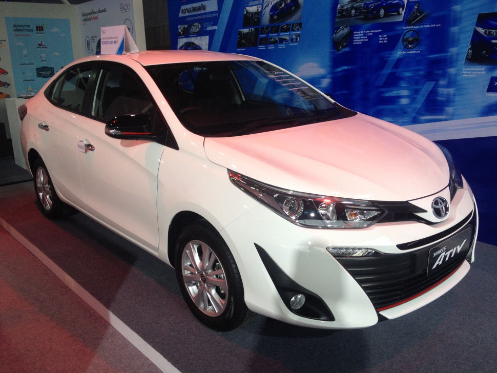 White sedan front side with sleek headlights and chrome details