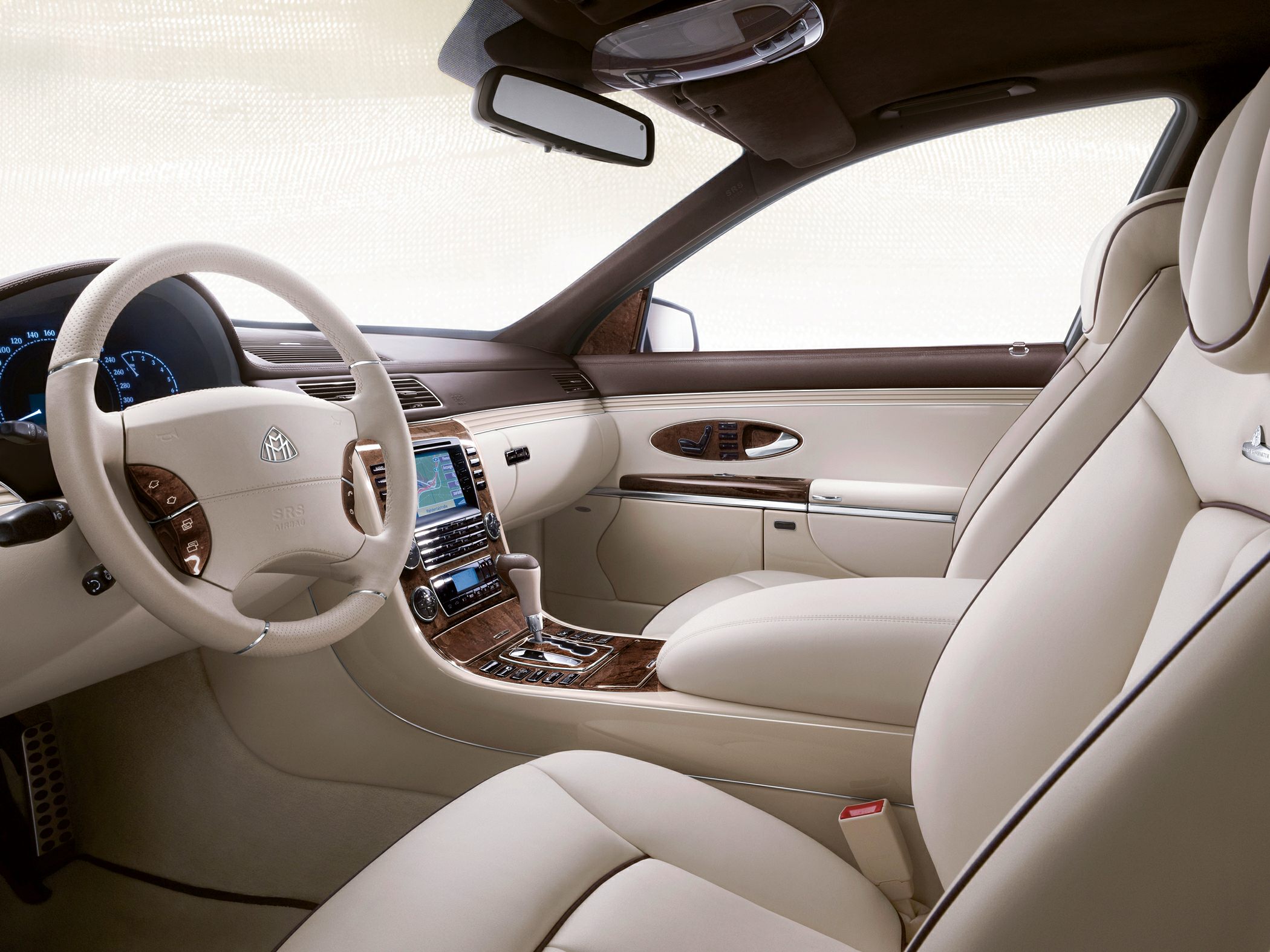 Beige leather seats and steering wheel with wood trim in luxury car interior