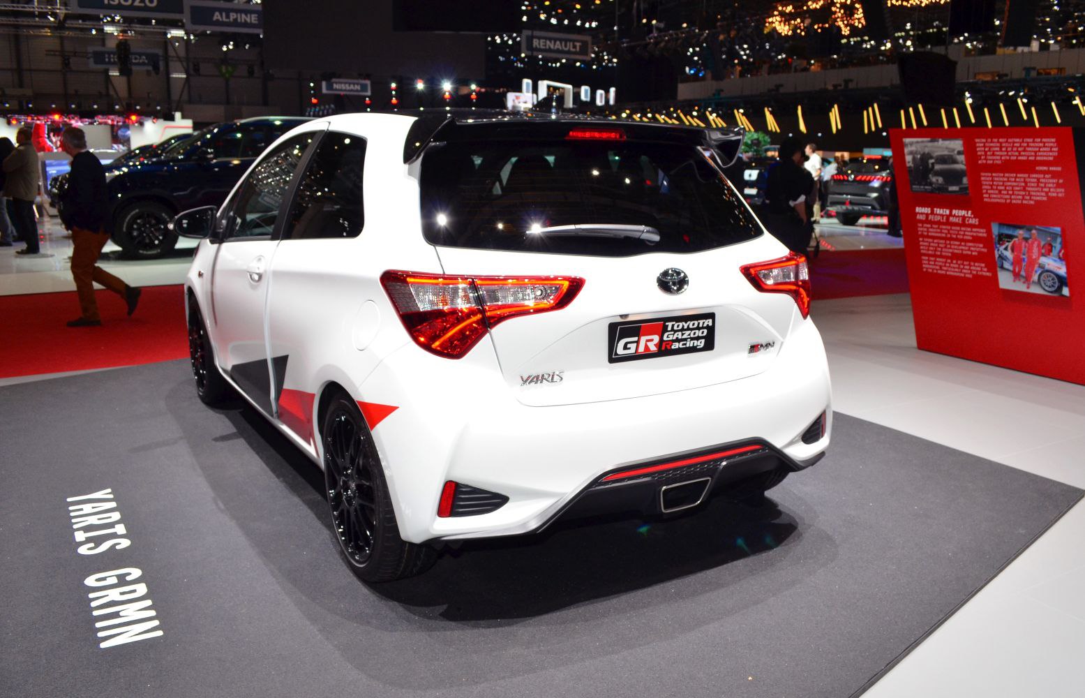 Rear view of white sporty hatchback with distinctive taillights and roof spoiler