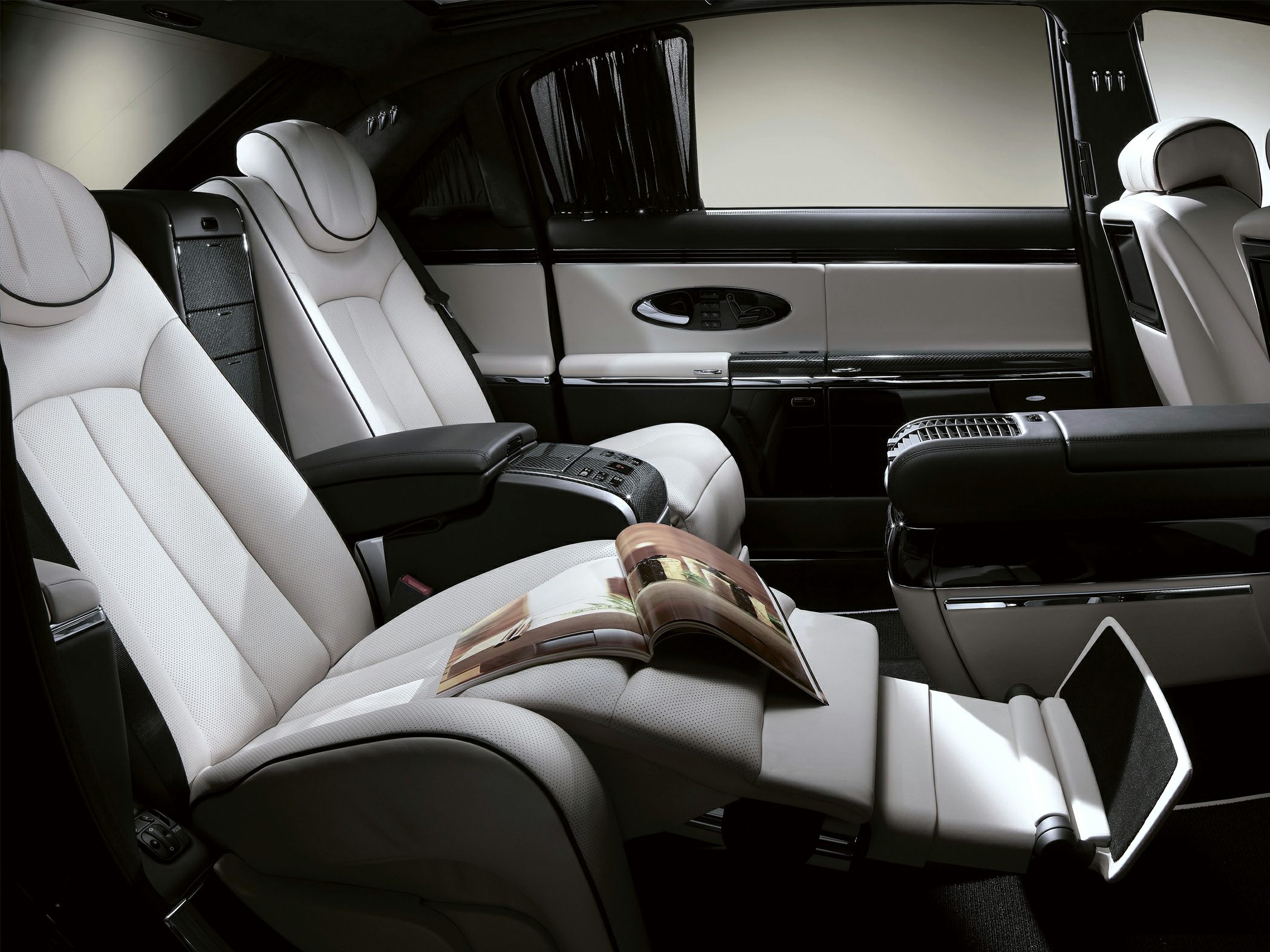 White plush luxury rear seats with reclining function and integrated controls