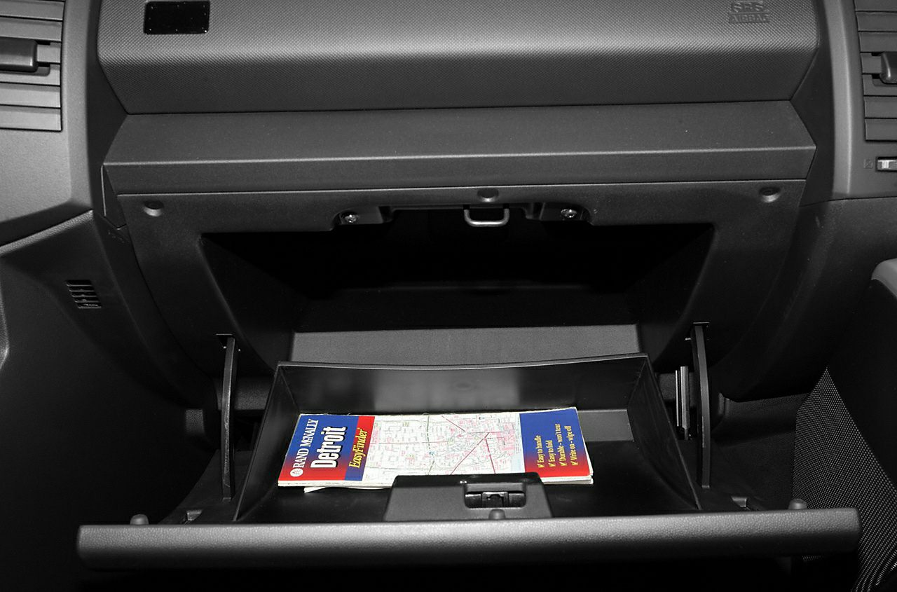 Open glove compartment with folded map inside