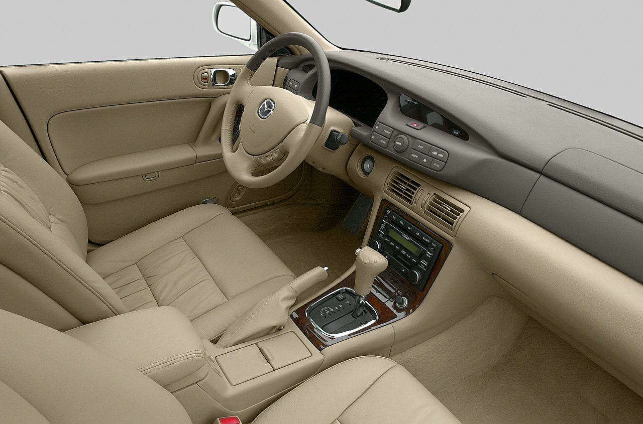 Beige leather seats and wood trim center console interior
