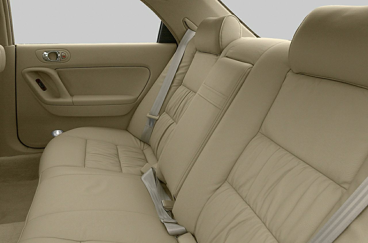Beige leather rear seat with door panel and seatbelt