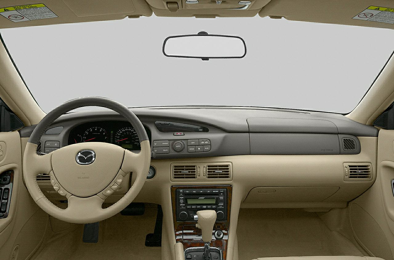 Beige interior dashboard and steering wheel of a vintage sedan