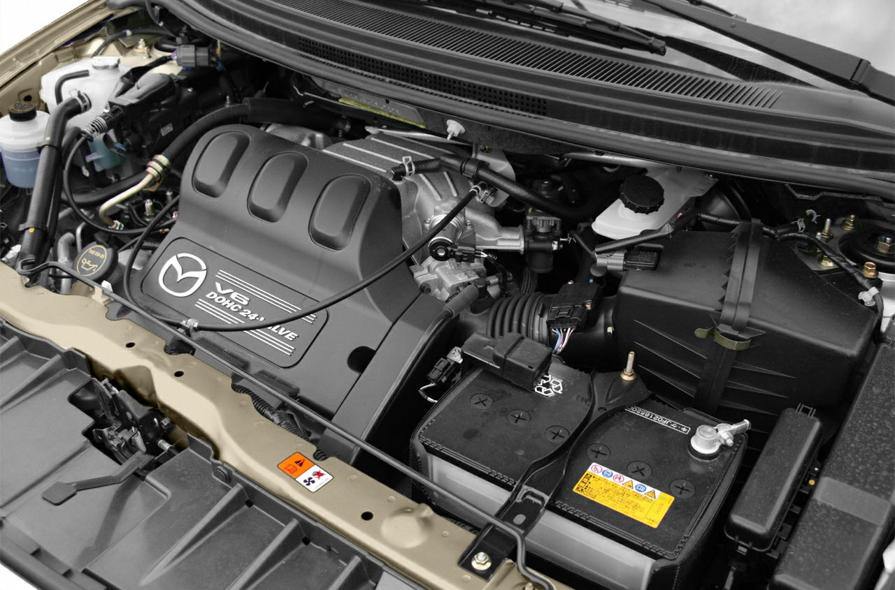 V6 DOHC 24-valve engine and car battery close-up