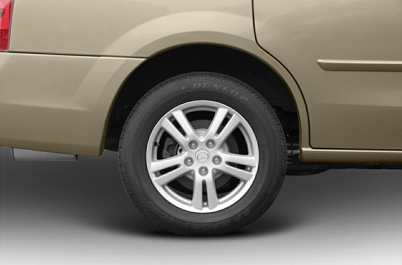 Rear wheel with alloy rim and Dunlop tire on fender