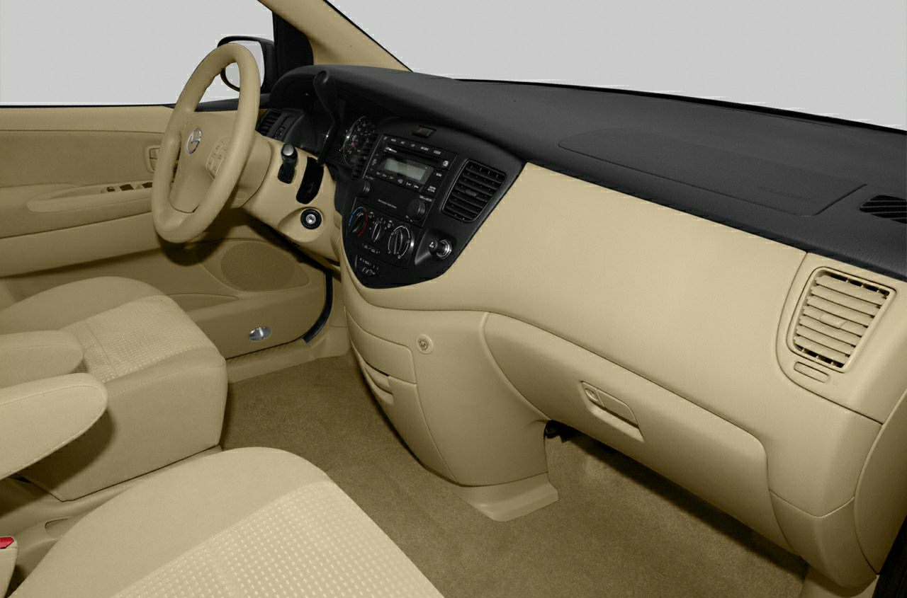 Beige interior with dashboard, steering wheel, and front seats.