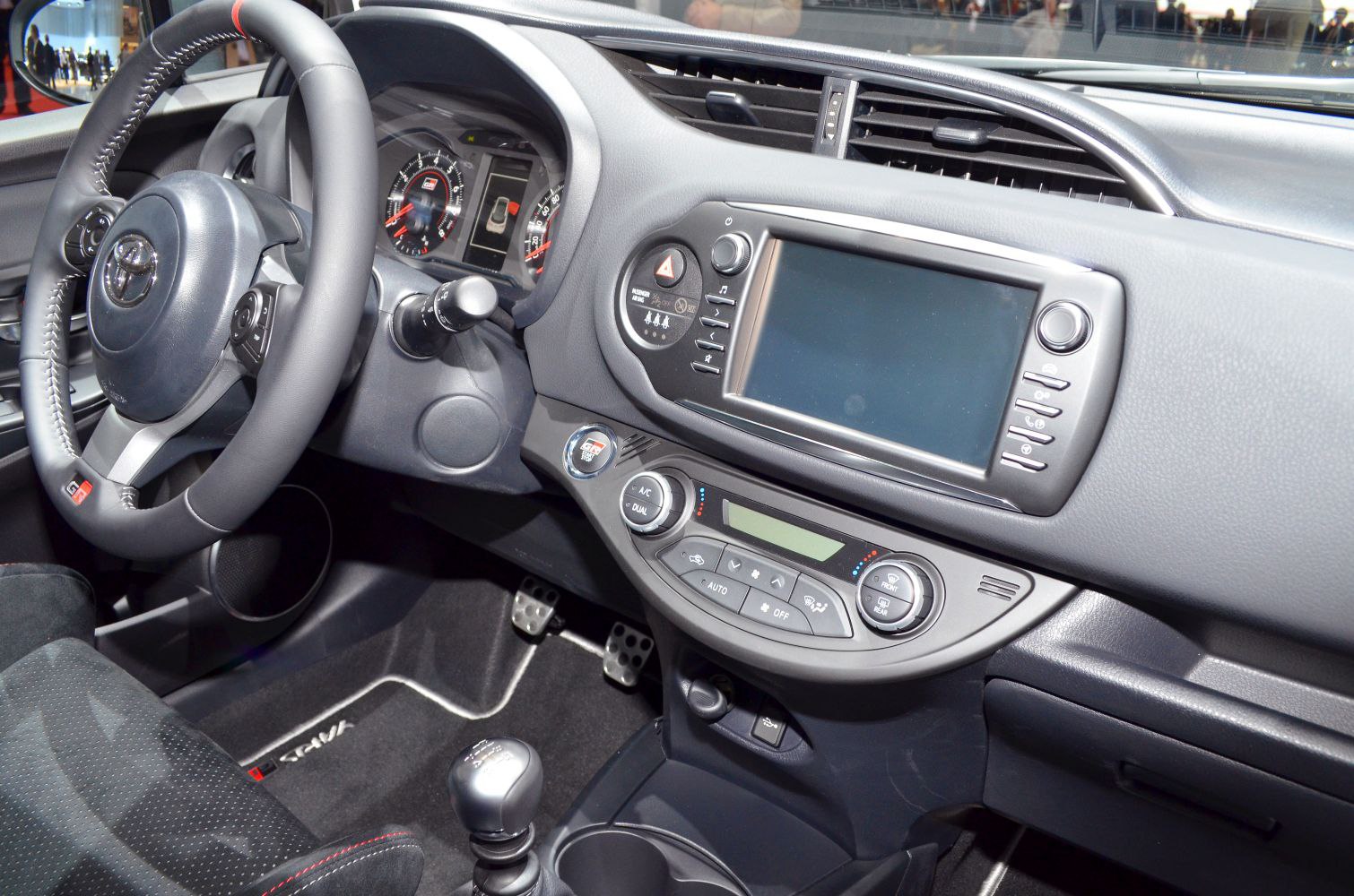 Dashboard, steering wheel, and center console controls in car interior