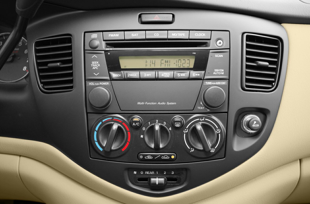 Dashboard audio system and climate control panel with knobs and buttons