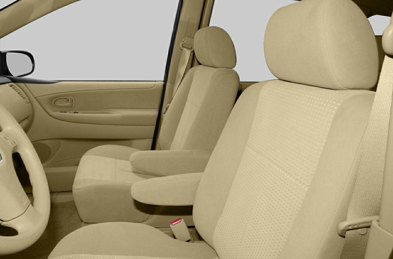 Beige fabric front seats with armrests and door panel