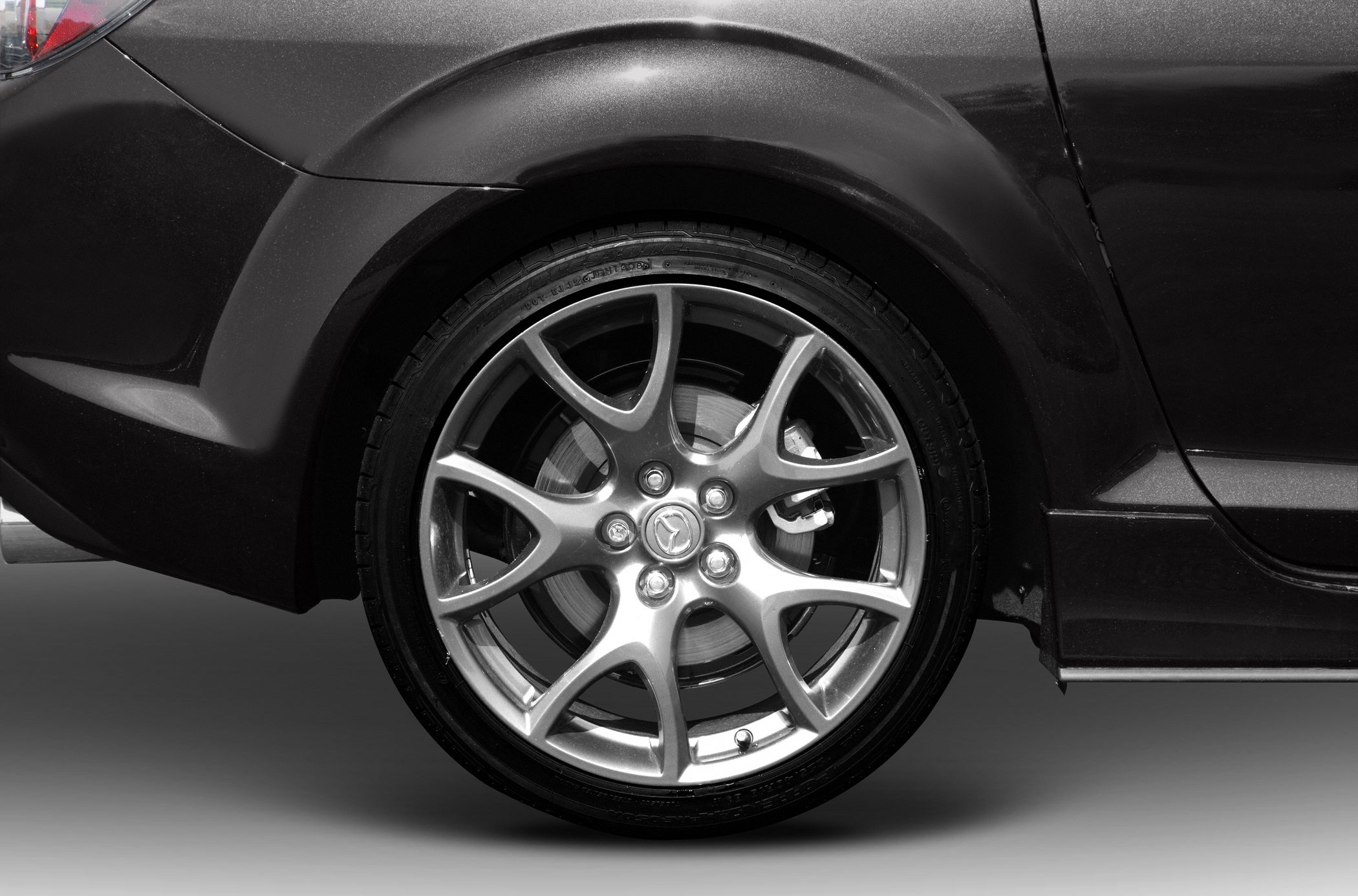 Alloy wheel and rear fender with visible brake caliper