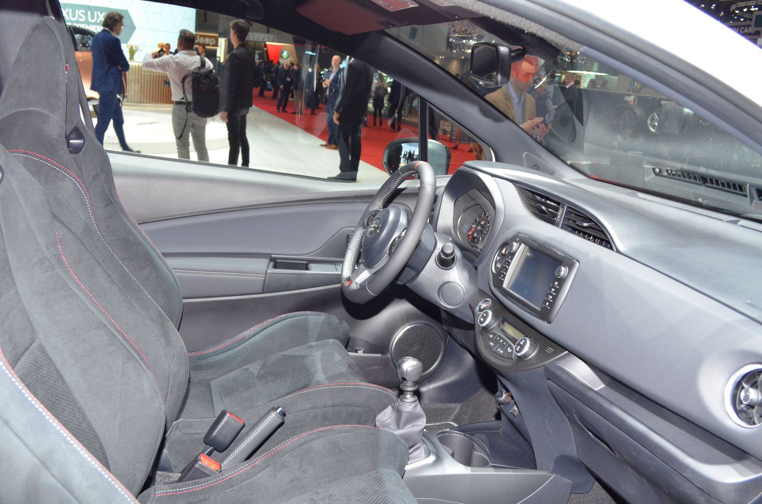 Sport seats and manual transmission cockpit with detailed dashboard