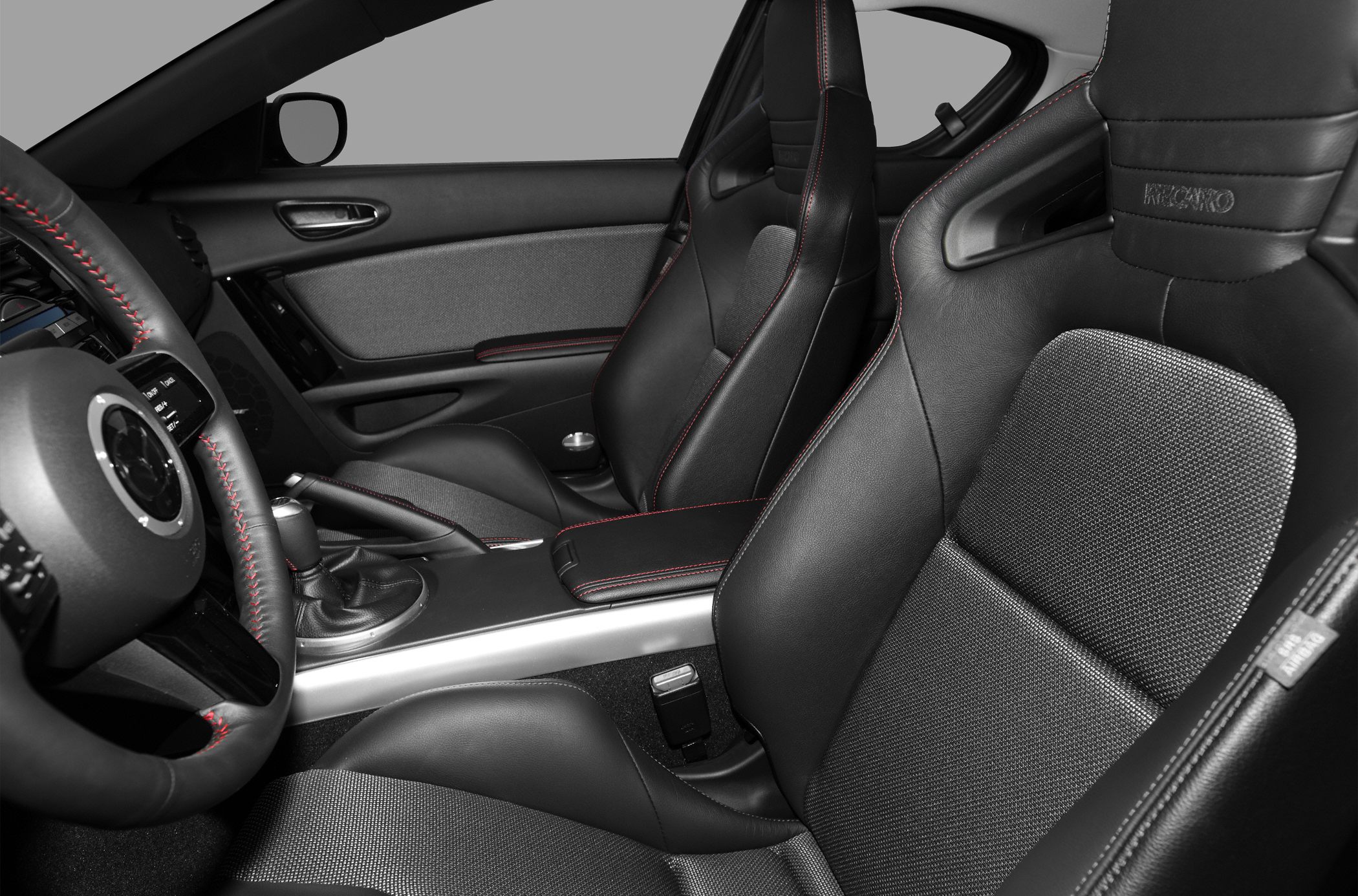 Sporty racing seats with black leather and red stitching