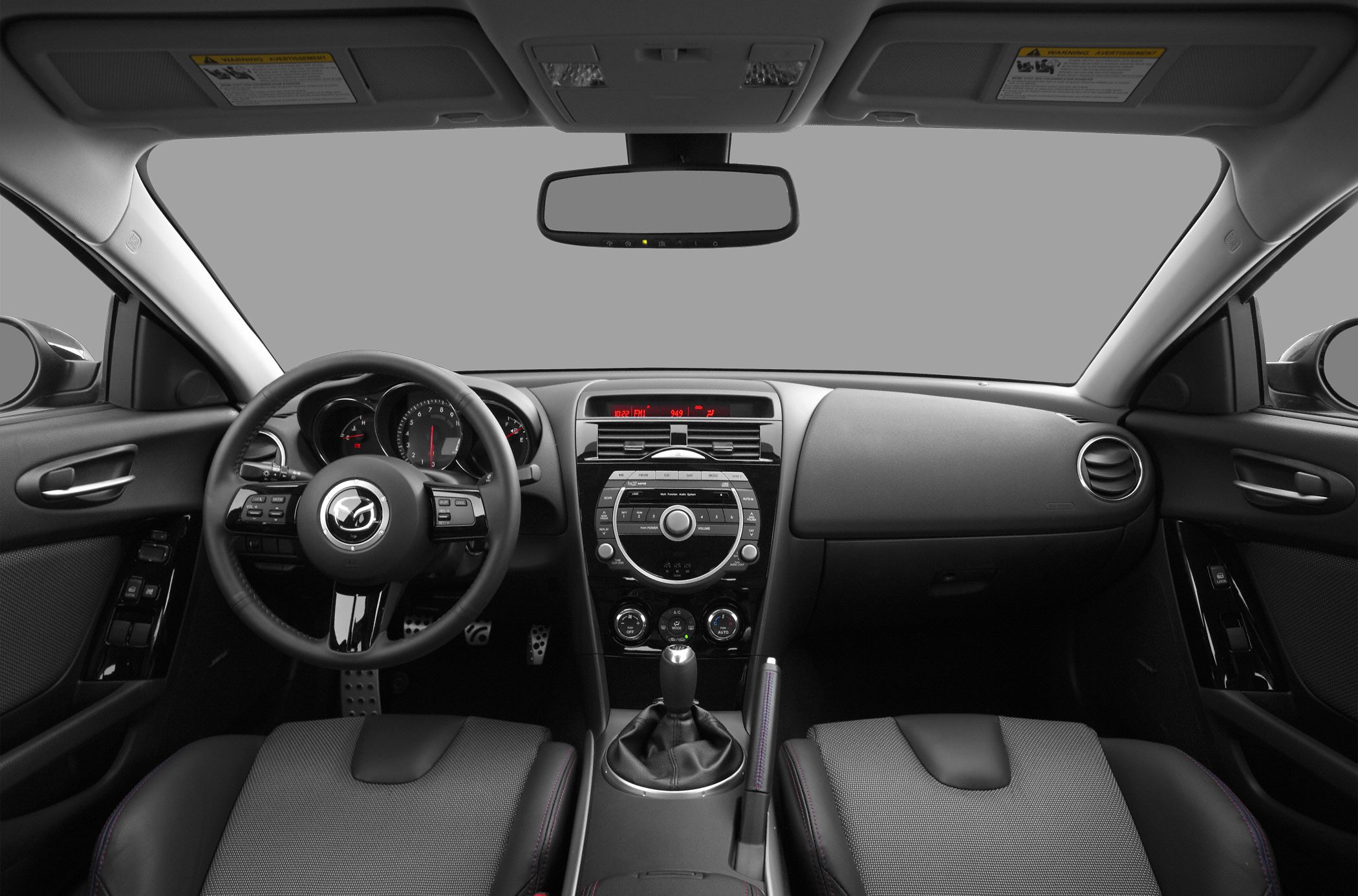 Steering wheel, dashboard with digital and analog controls, manual gearshift